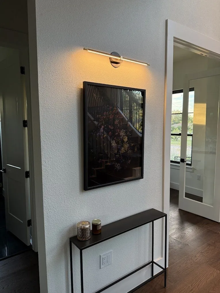 Accent lighting on a client's art wall — licensed residential electrician in Austin TX (DC Electric)