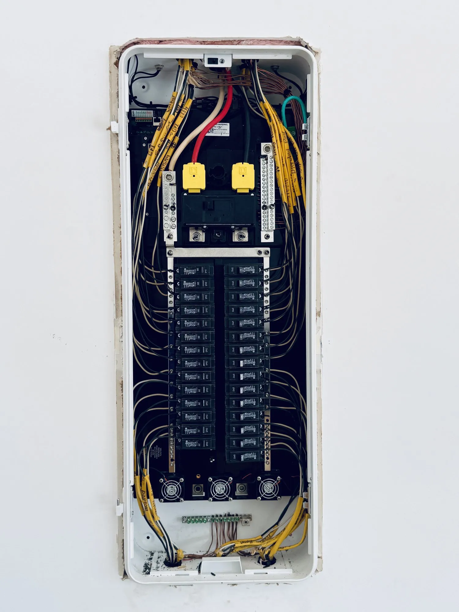 Inside a cleanly wired residential electrical panel in Austin — conductors routed and torqued, breakers seated, directory legible.