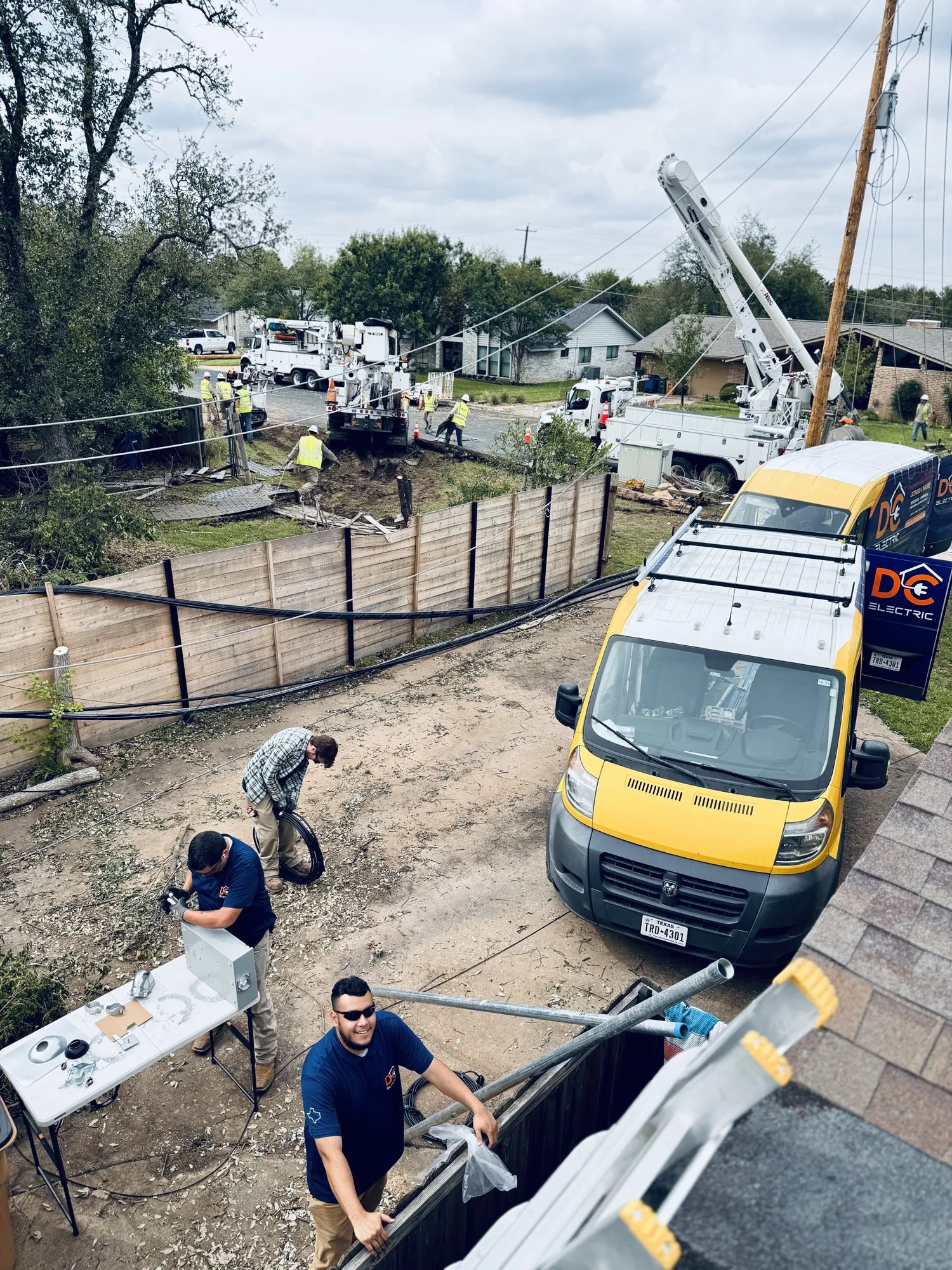Crew and bucket truck on a service upgrade — licensed residential electrician in Austin TX (DC Electric)
