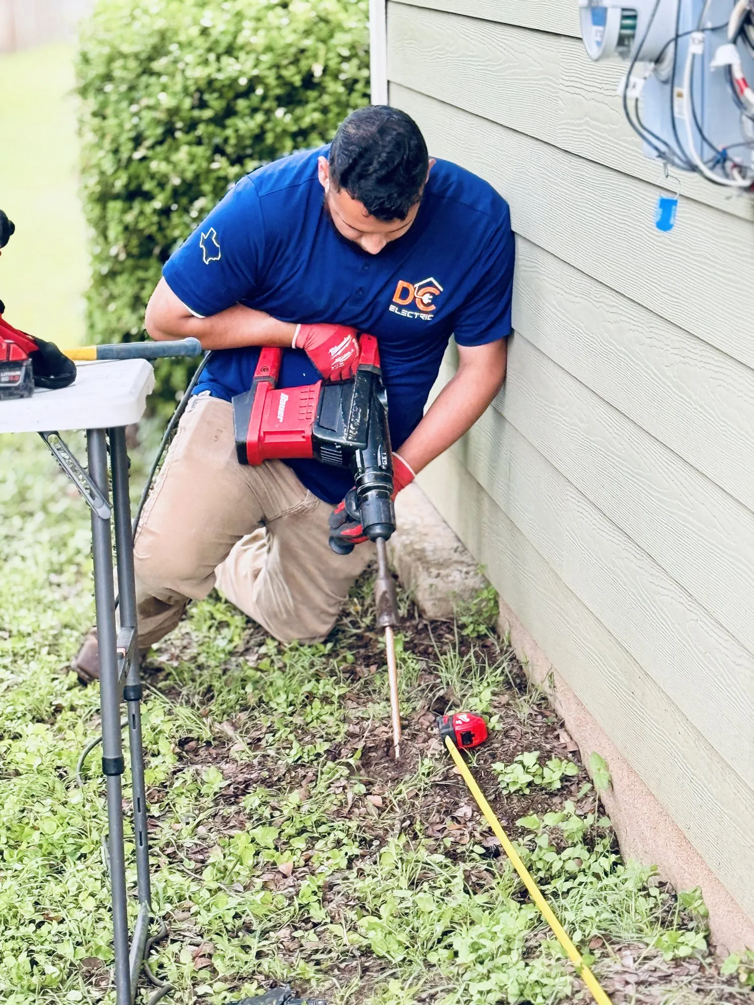 Driving a ground rod with a rotary hammer — licensed residential electrician in Austin TX (DC Electric)