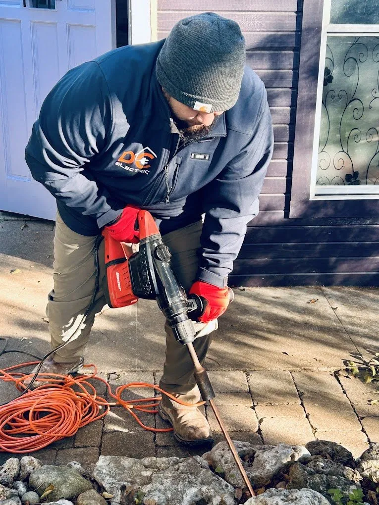 Driving a ground rod into Texas soil — licensed residential electrician in Austin TX (DC Electric)