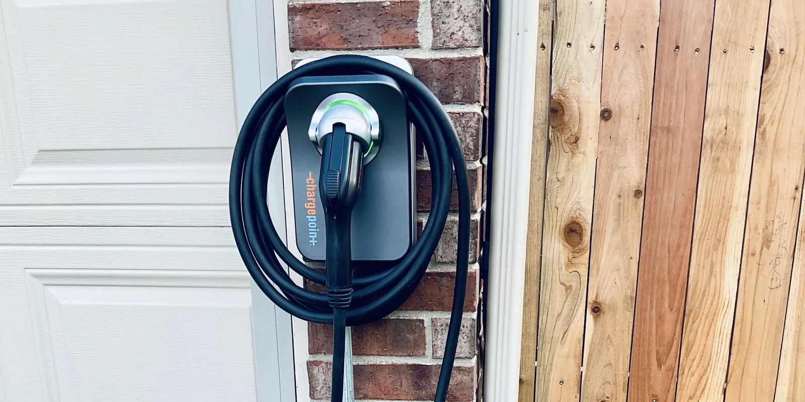 A ChargePoint Level 2 EV charger installed outdoors on the exterior wall of an Austin home.