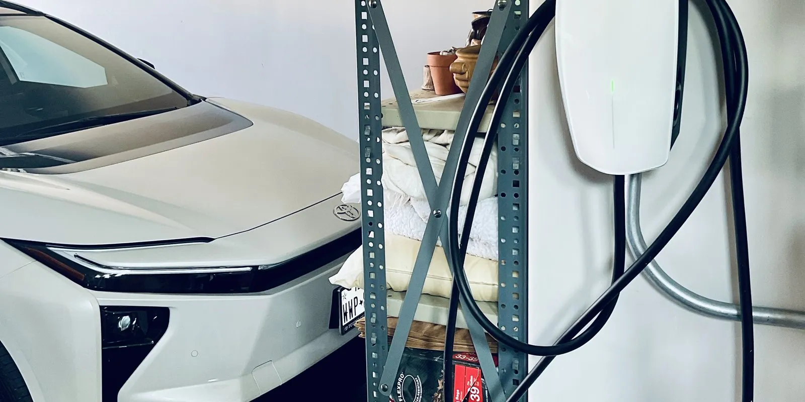 A Tesla Universal Wall Connector installed in an Austin garage next to the homeowner's EV.