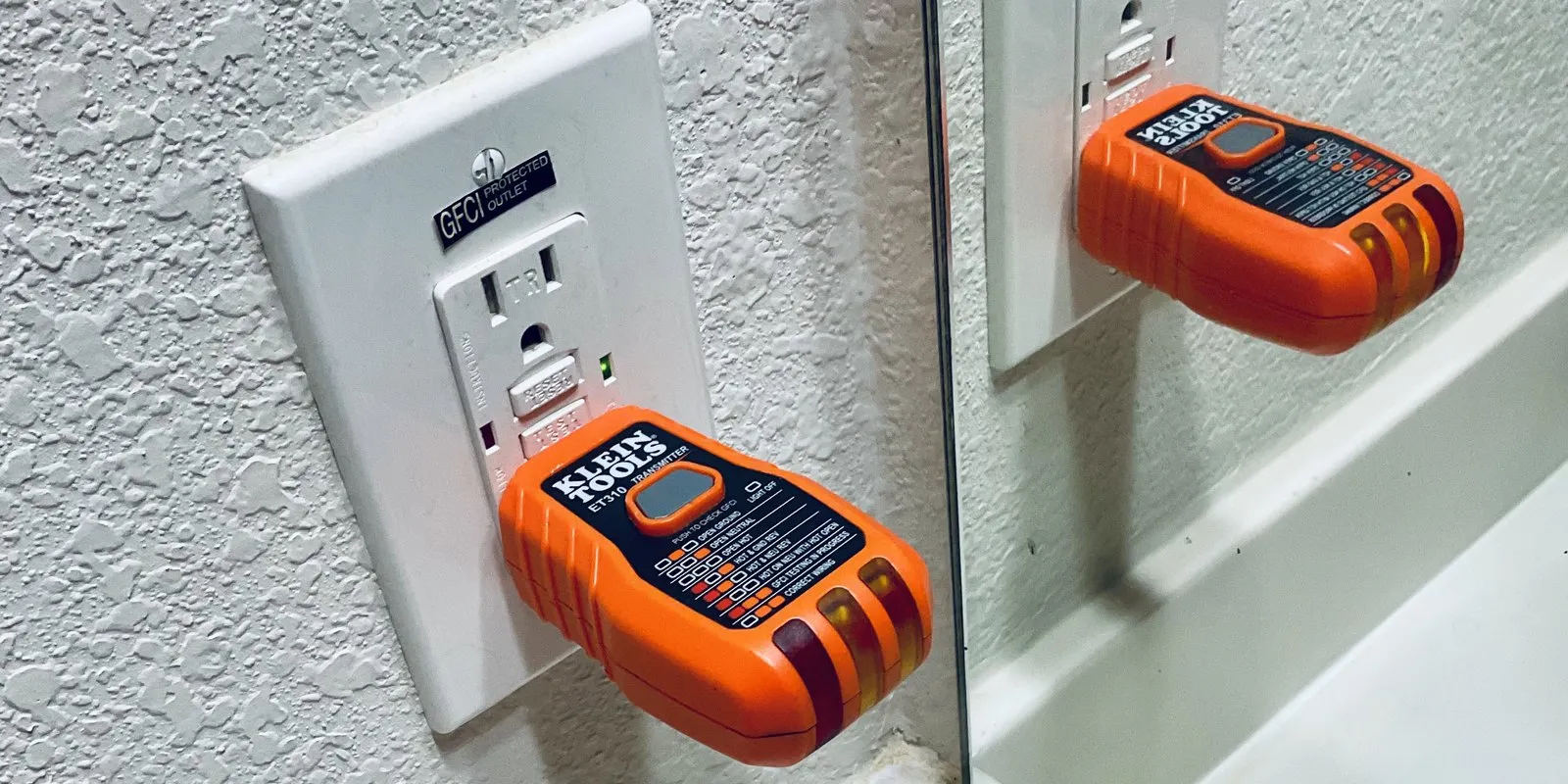 A GFCI outlet in an Austin home being tested with a plug-in circuit tester.