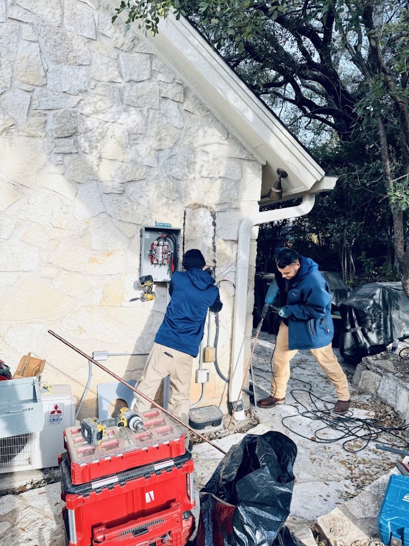 DC Electric technicians verifying and installing copper grounding electrodes at an Austin residence