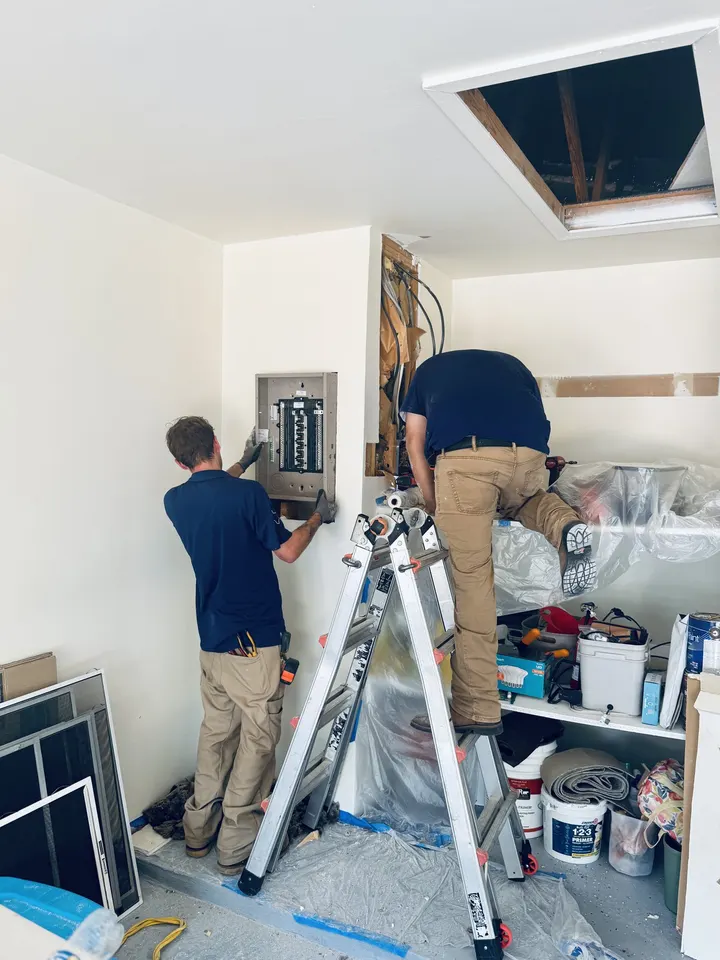 DC Electric technicians diagnosing a tripping breaker in a Hutto TX garage panel